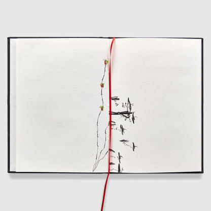 The book is open to two pages. There is a black and white drawing going up the spine with a red ribbon bookmark down the middle of the pages.