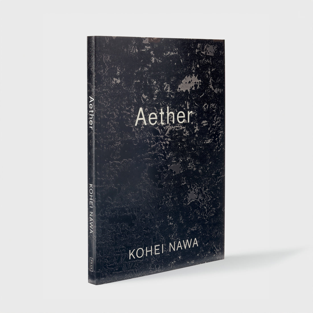 Aether Kohei Nawa. The font is white and the cover has a reflective black Nawa work.