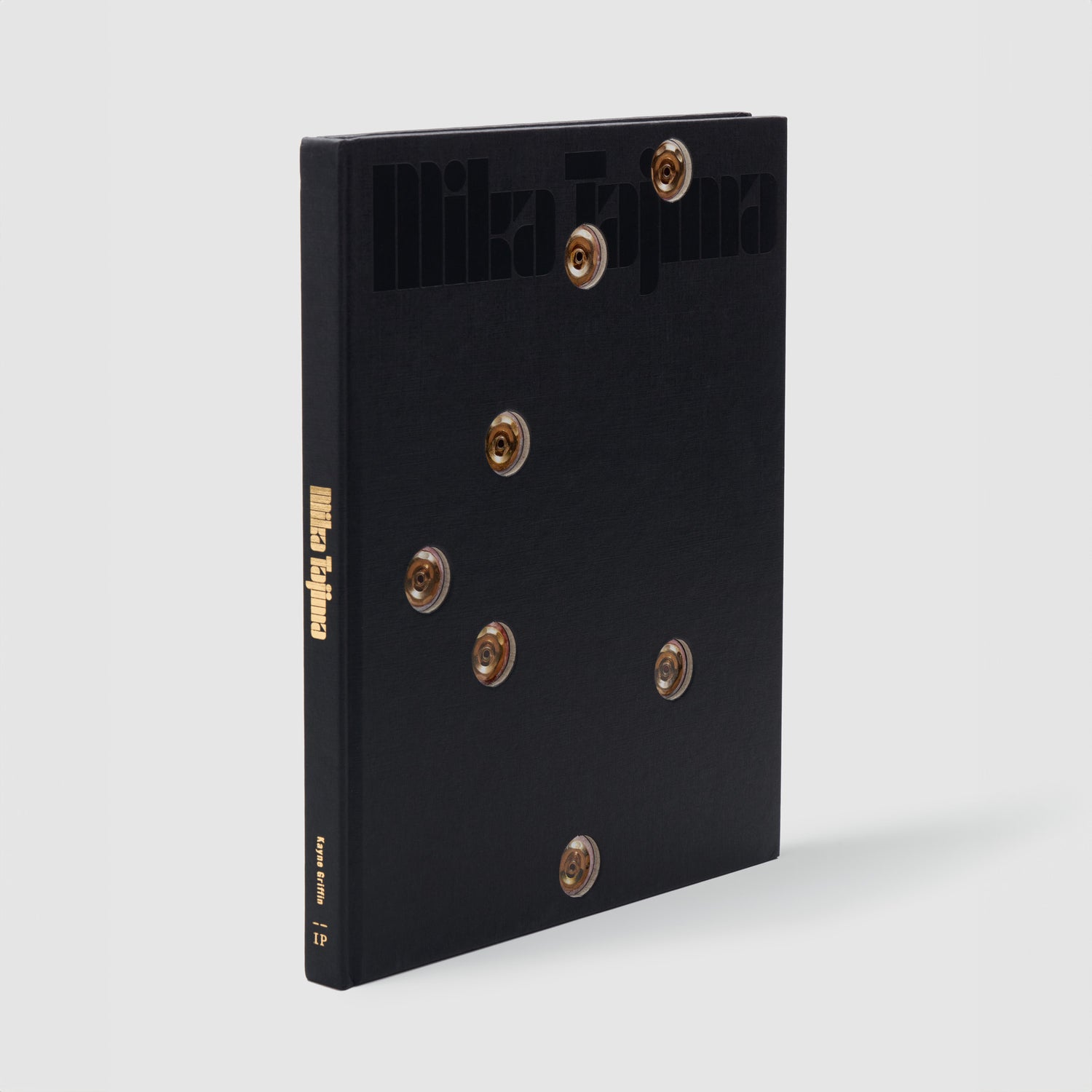 Mika Tajima. The book has a black cover with gold hot tub nozzle details.