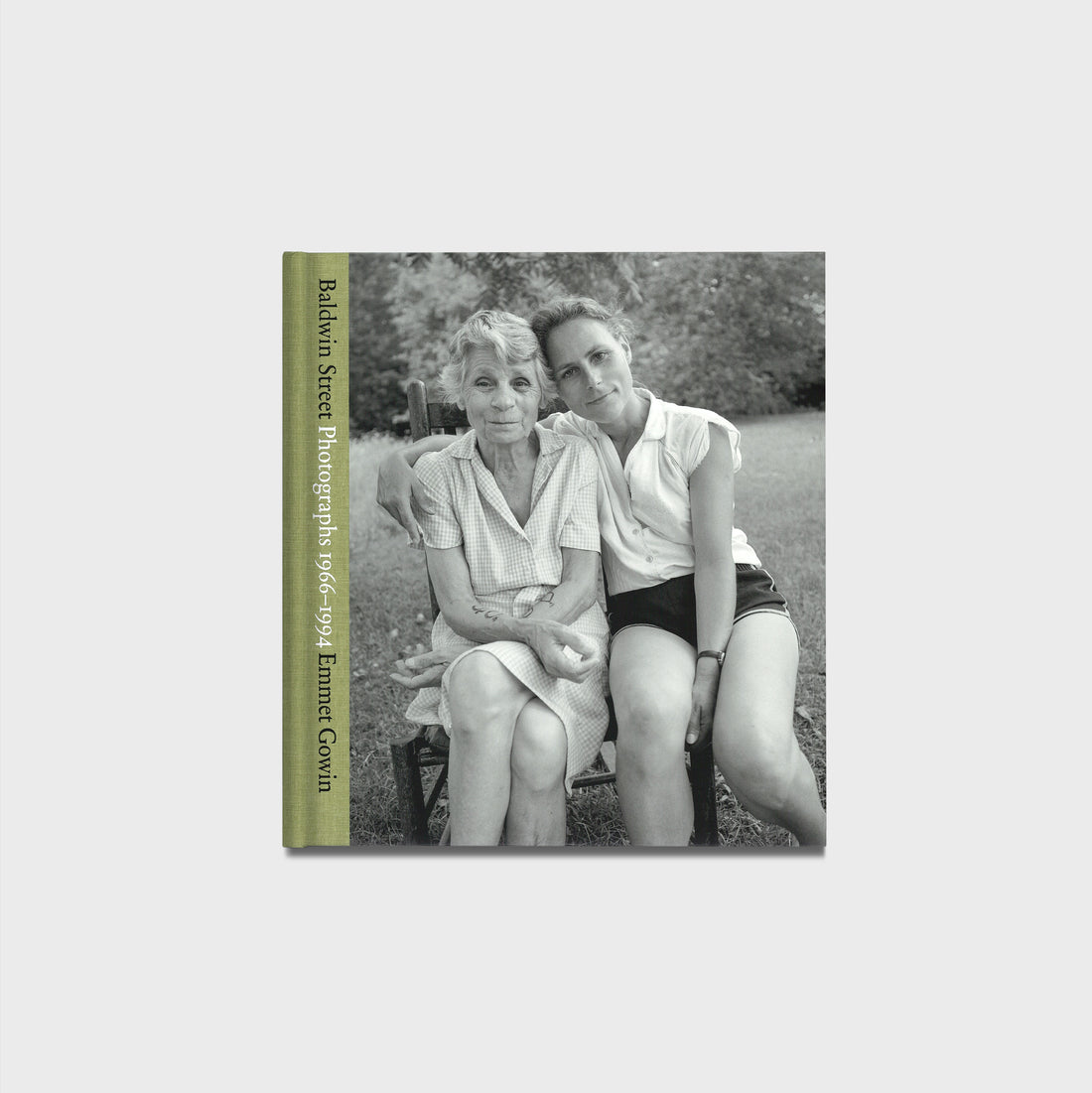 Book cover with black and white photo of two people sitting on a bench, green text on the side.