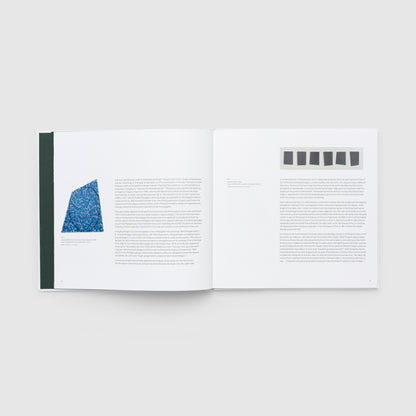 Open book with text and a blue abstract design on a white background