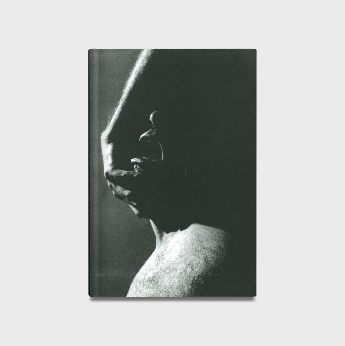Book cover with a black and white photograph of a hand on a face against a plain background. 
