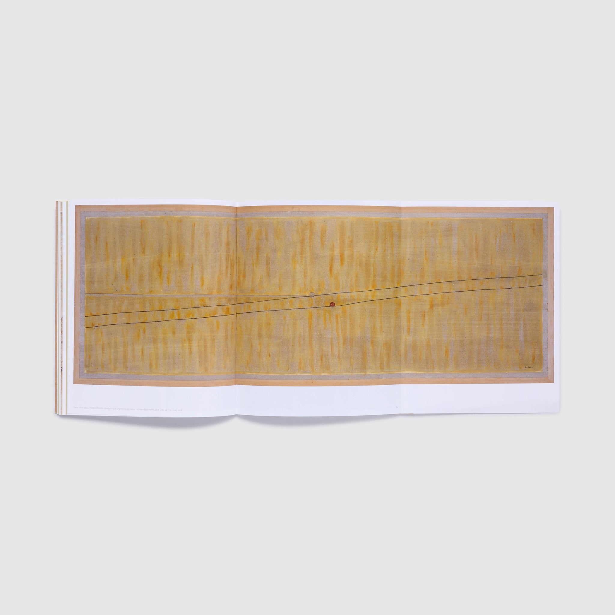 The book is open with a fold out fully unfolded. The foldout is three pages wide and has a Dodinh painting across it.