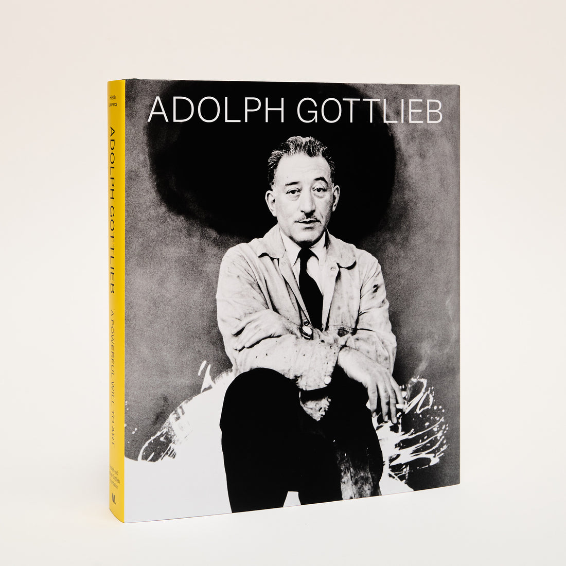 The background of the book cover is a black and white portrait of Adolph Gottlieb. The title &quot;Adolph Gottlieb&quot; is in white. The book spine is bright yellow.