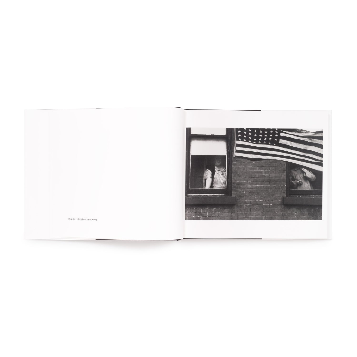 The book is open to two pages. There is a black and white photo by Robert Frank on the right page and information on the photo on the left page.