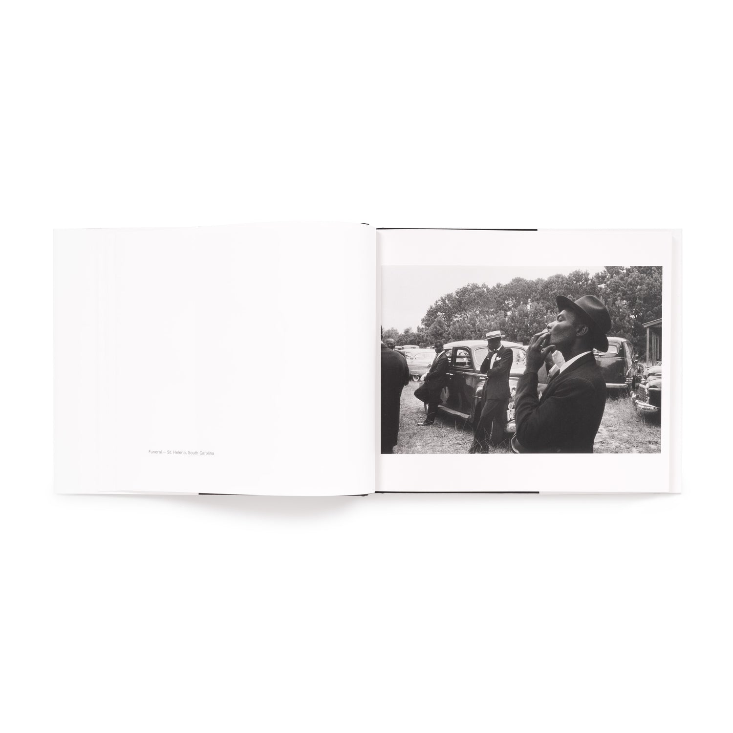 The book is open to two pages. There is a black and white photo by Robert Frank on the right page and information on the photo on the left page.